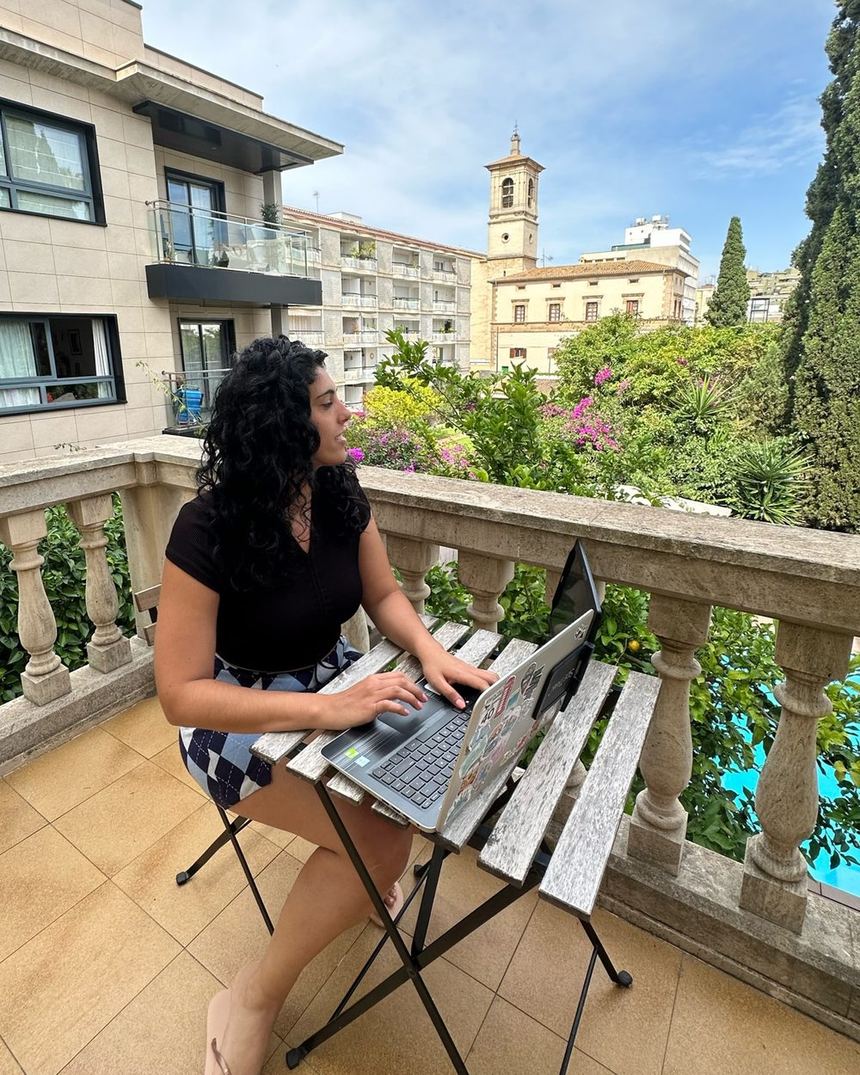 Agustina De Adamo working on her laptop